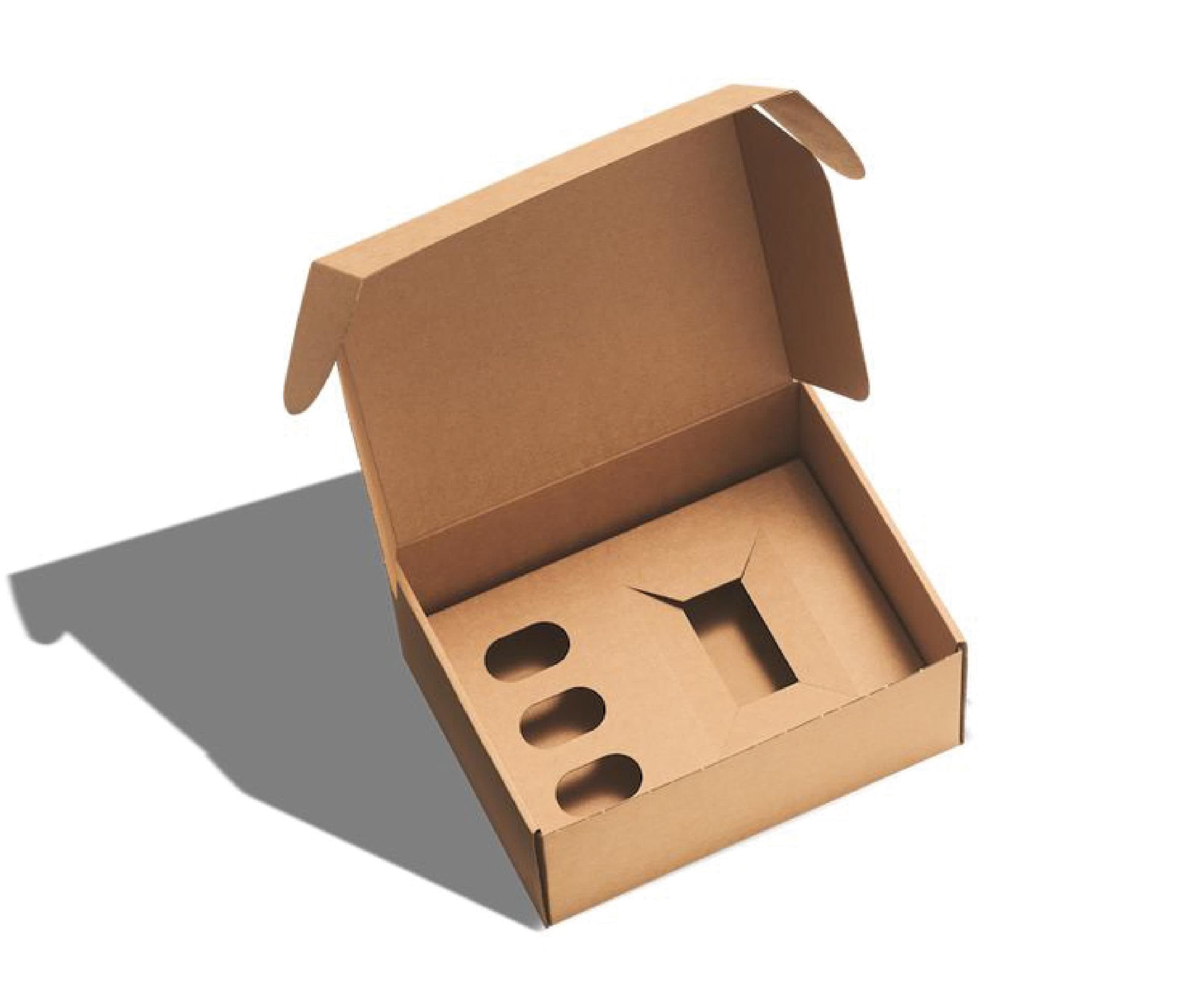 An open die-cut corrugated box on white with a fitted insert, cut with shaped recesses to hold a product and three smaller items in place.